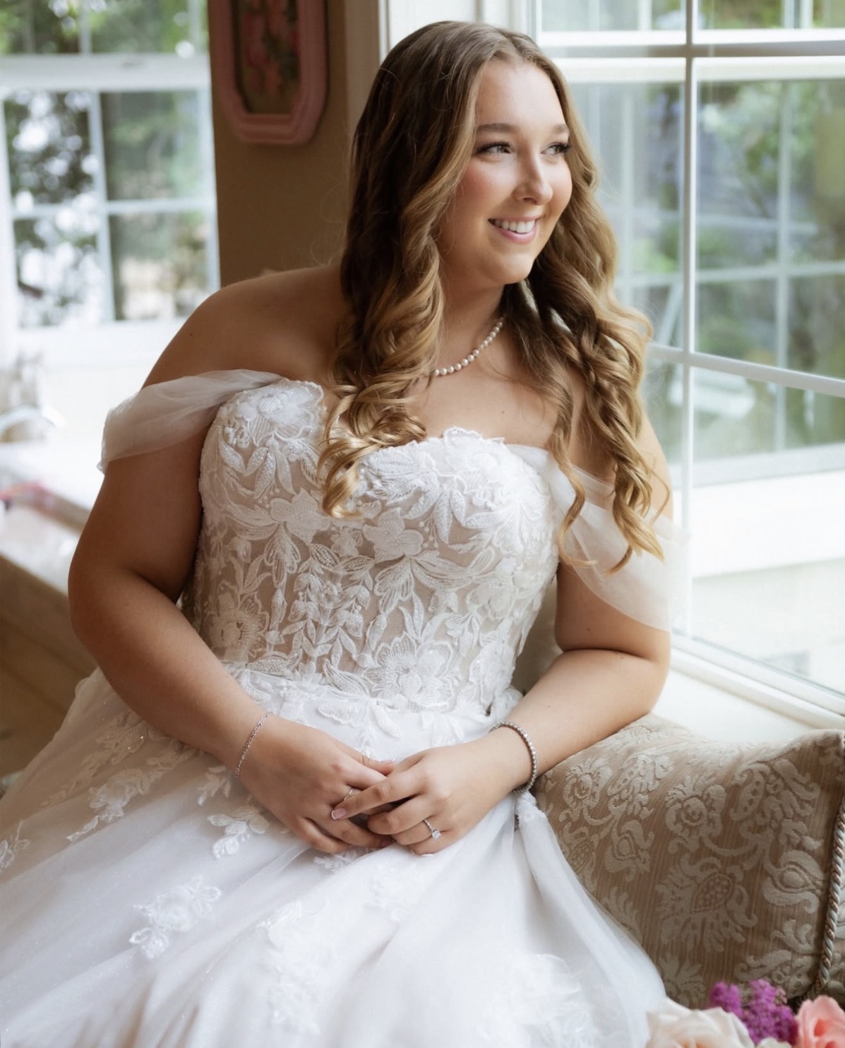 Bride in the window light wearing romantic wedding makeup